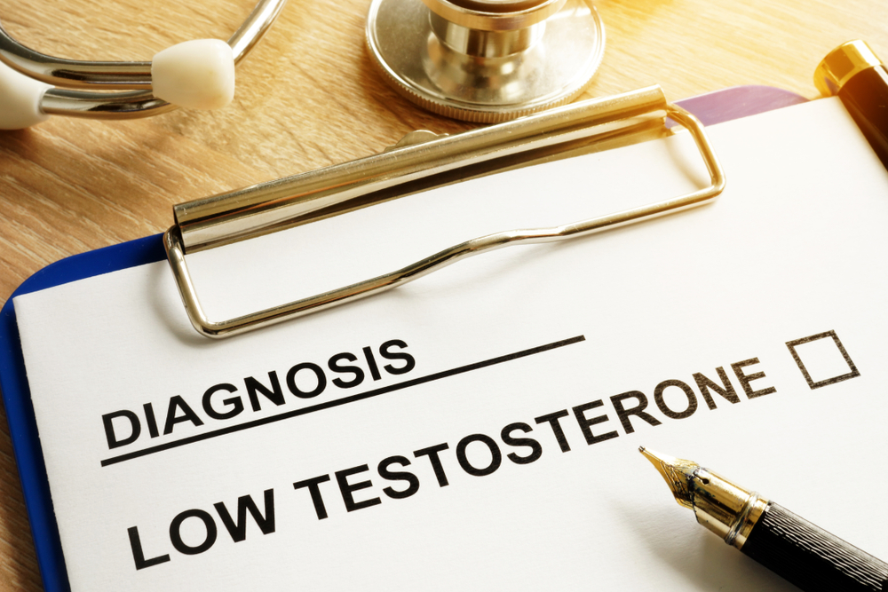 Diagnosis of Low testosterone on clipboard and pen on a desk.